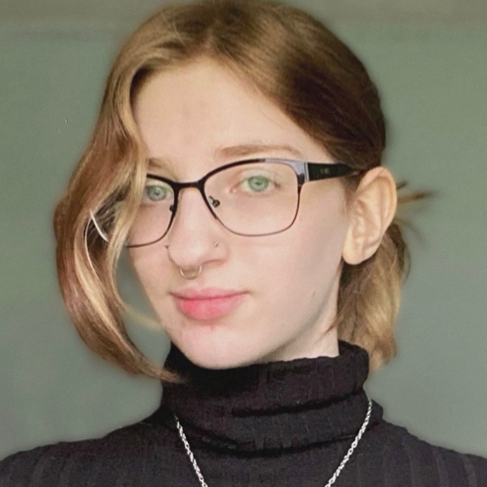 A photo of me, Allison. Wearing a black turtleneck with a green-blue background. My hair is in a ponytail and I am wearing glasses.